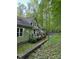 Backyard view featuring a deck, a retaining wall, and lush greenery, ideal for relaxing and enjoying nature at 113 Duval Ct, Mooresville, NC 28117