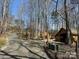 Long driveway leads to a serene setting with charming wooden buildings at 113 Duval Ct, Mooresville, NC 28117