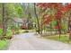 Charming home nestled among trees, featuring a gravel driveway and lush landscaping for a serene and private setting at 113 Duval Ct, Mooresville, NC 28117