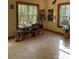 Bright living room featuring large windows, hardwood trim, and multiple plants at 113 Duval Ct, Mooresville, NC 28117