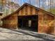 Exterior of a large wooden outbuilding, featuring horseshoe decorations, and an open front at 113 Duval Ct, Mooresville, NC 28117