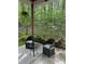 Relaxing patio features comfortable seating and a peaceful view of the wooded backyard at 113 Duval Ct, Mooresville, NC 28117