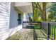 A weathered wood deck with a black railing offers outdoor relaxation space near a white home exterior at 1157 Cedar Grove Ln, Rock Hill, SC 29732