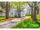Quaint home with a well-maintained lawn, gravel driveway, and a welcoming front porch at 1157 Cedar Grove Ln, Rock Hill, SC 29732