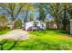 Charming home with lush lawn, gravel drive, and inviting small porch in a tranquil setting at 1157 Cedar Grove Ln, Rock Hill, SC 29732