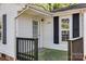Close-up of the front porch of a home featuring dark wood railing, white trim, and well-maintained exterior at 1157 Cedar Grove Ln, Rock Hill, SC 29732