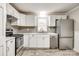 Well-lit kitchen features stainless steel appliances and white cabinets at 1157 Cedar Grove Ln, Rock Hill, SC 29732