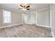 Bright living room showcasing wood-look floors, a ceiling fan, and a doorway leading to other rooms at 1157 Cedar Grove Ln, Rock Hill, SC 29732