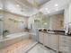 Bright bathroom with a soaking tub, glass shower, and a marble vanity at 1206 Heatherloch Dr, Gastonia, NC 28054