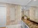Bathroom with marble countertops, fern wallpaper, and decorative mirror at 1206 Heatherloch Dr, Gastonia, NC 28054