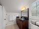 Bathroom features a dark wood vanity, granite countertop, window, and framed mirror at 1206 Heatherloch Dr, Gastonia, NC 28054