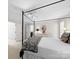 Main bedroom with a four-poster bed, soft natural light, and seamless access to an en-suite bathroom at 1206 Heatherloch Dr, Gastonia, NC 28054