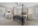 Main bedroom features soft natural light, a four-poster bed, and a stylish decor at 1206 Heatherloch Dr, Gastonia, NC 28054