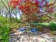 Garden featuring chairs, bistro table, shade tree, and flowers at 1206 Heatherloch Dr, Gastonia, NC 28054