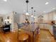 Open kitchen with large island, granite countertops, custom cabinets, and stainless appliances at 1206 Heatherloch Dr, Gastonia, NC 28054