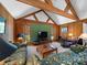 Large open living room with wooden walls, vaulted ceilings, and lots of natural light at 1206 Heatherloch Dr, Gastonia, NC 28054