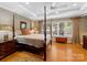 Main bedroom with hardwood floors, large windows, and a four-poster bed at 1206 Heatherloch Dr, Gastonia, NC 28054