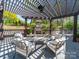 Outdoor patio area with dark pergola, fireplace, and ample seating at 1206 Heatherloch Dr, Gastonia, NC 28054