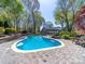 Backyard featuring kidney-shaped pool, patio, landscaping, and more at 1206 Heatherloch Dr, Gastonia, NC 28054