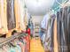 Walk-in closet featuring custom shelving, organized racks, and hardwood floors at 1206 Heatherloch Dr, Gastonia, NC 28054