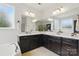 Bright bathroom featuring double vanity, quartz countertops, and sleek espresso-stained cabinets at 1224 Screech Owl Rd, Waxhaw, NC 28173