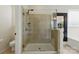 Tiled shower with glass doors, next to a toilet in the water closet at 1224 Screech Owl Rd, Waxhaw, NC 28173