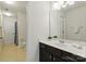 Bathroom with a white door, toilet, white countertops, dark cabinets, and beige flooring at 1224 Screech Owl Rd, Waxhaw, NC 28173