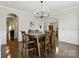 Dining room with a wooden table and chairs, chandelier, and a view into other rooms at 1224 Screech Owl Rd, Waxhaw, NC 28173