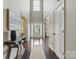 Bright entryway featuring hardwood floors, a high ceiling, and a view of the front door at 1224 Screech Owl Rd, Waxhaw, NC 28173