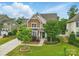 Charming two-story home with a manicured lawn, mature trees, and inviting front entrance at 1224 Screech Owl Rd, Waxhaw, NC 28173