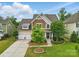 Inviting two-story home with a two-car garage, well-kept lawn, and attractive landscaping at 1224 Screech Owl Rd, Waxhaw, NC 28173