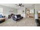 Living room featuring a modern futon, carpeted floors, and plenty of natural light at 1224 Screech Owl Rd, Waxhaw, NC 28173