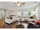 Spacious living room with hardwood floors, large windows, shiplap walls and a ceiling fan at 1224 Screech Owl Rd, Waxhaw, NC 28173