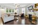 Bright living room with hardwood floors, a fireplace, ceiling fan, and large windows at 1224 Screech Owl Rd, Waxhaw, NC 28173