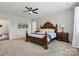 Bedroom featuring plush carpet, a ceiling fan, ensuite bathroom and ample natural light at 1224 Screech Owl Rd, Waxhaw, NC 28173