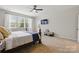 Bedroom with plush carpet, a ceiling fan, ensuite bathroom and large windows offering natural light at 1224 Screech Owl Rd, Waxhaw, NC 28173