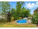 Cozy backyard pool surrounded by lush landscaping and a classic white picket fence for outdoor relaxation at 1224 Screech Owl Rd, Waxhaw, NC 28173