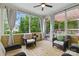 Cozy screened porch with outdoor seating, wood flooring, and open view of trees at 1224 Screech Owl Rd, Waxhaw, NC 28173