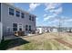 A view of the backyard, showcasing the patio area, lawn, and surrounding neighborhood homes at 1243 Pebble Grove Dr # 442, Clover, SC 29710