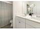 Bright bathroom featuring a double sink vanity with a white countertop and decorative white orchids at 1243 Pebble Grove Dr # 442, Clover, SC 29710