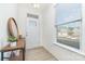 A bright foyer with wood floors, large front window, wood console table, and a mirror at 1243 Pebble Grove Dr # 442, Clover, SC 29710