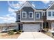 Two-story townhome featuring a gray facade, attached two-car garage, and landscaping at 1243 Pebble Grove Dr # 442, Clover, SC 29710