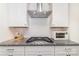 Modern kitchen features stainless steel range hood, white cabinets, and granite countertops at 1243 Pebble Grove Dr # 442, Clover, SC 29710