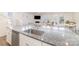 Spacious kitchen island with a stainless steel sink and granite countertop overlooks the living area at 1243 Pebble Grove Dr # 442, Clover, SC 29710