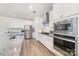 A bright, white kitchen showcases stainless steel appliances and sleek countertops at 1243 Pebble Grove Dr # 442, Clover, SC 29710