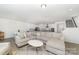 Spacious, open-concept living room with a cozy sofa, kitchen, and staircase access at 1243 Pebble Grove Dr # 442, Clover, SC 29710