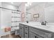 Bright bathroom features a double sink vanity, neutral paint and cheerful rainbow-themed wallpaper at 1255 Fishing Creek Rd, Clover, SC 29710