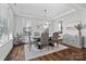 Elegant dining room with modern chandelier, tray ceiling, and large windows for natural light at 1255 Fishing Creek Rd, Clover, SC 29710