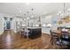 Bright kitchen with white cabinets, stainless steel appliances, dark island, and hardwood flooring at 1255 Fishing Creek Rd, Clover, SC 29710