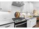 Modern kitchen with a gas range, white subway tile backsplash, and dark countertops at 1255 Fishing Creek Rd, Clover, SC 29710